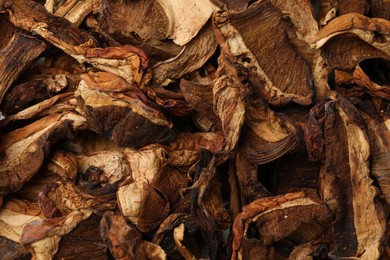 Photo of Pieces of dried mushrooms as background, top view