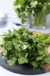 Photo of Fresh green cilantro on light table, closeup