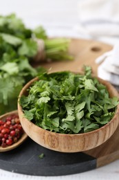 Photo of Fresh green cilantro and peppercorns on table, closeup