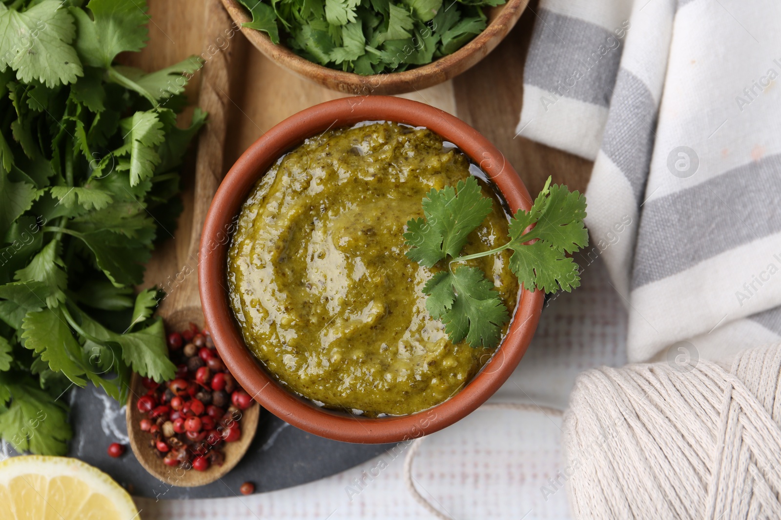 Tasty sauce with cilantro and other ingredients on white wooden table, top view Photo of Tasty sauce with cilantro and other ingredients on white wooden table, top view