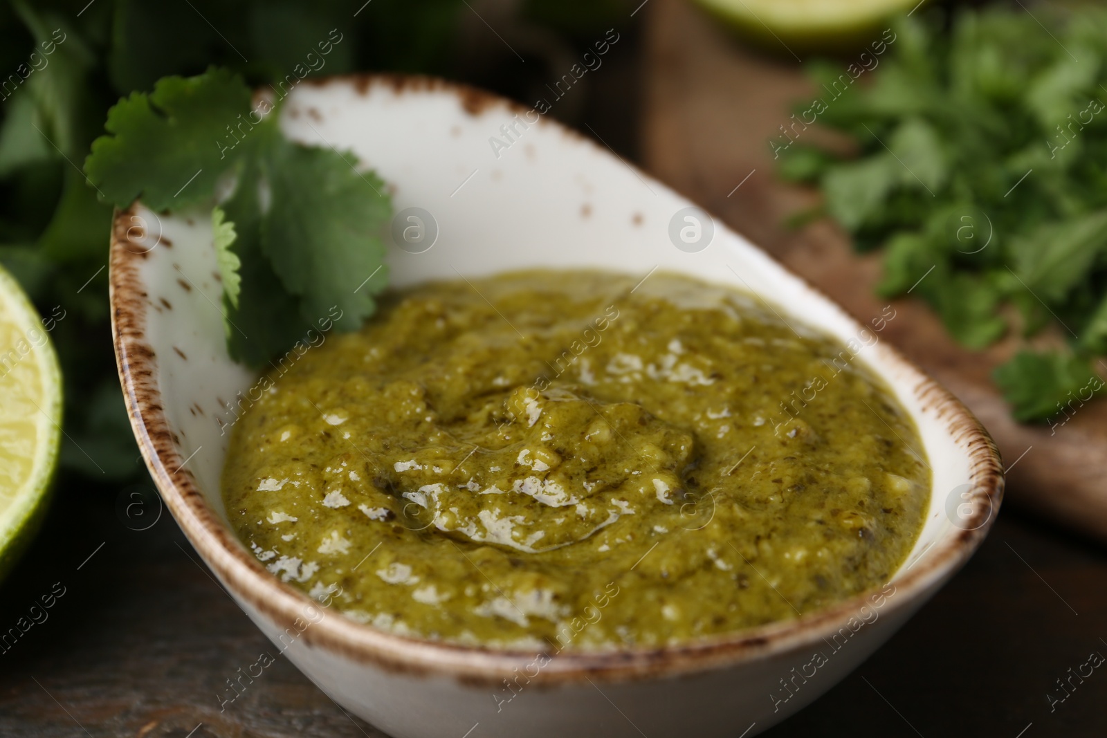 Tasty sauce with cilantro on table, closeup Photo of Tasty sauce with cilantro on table, closeup
