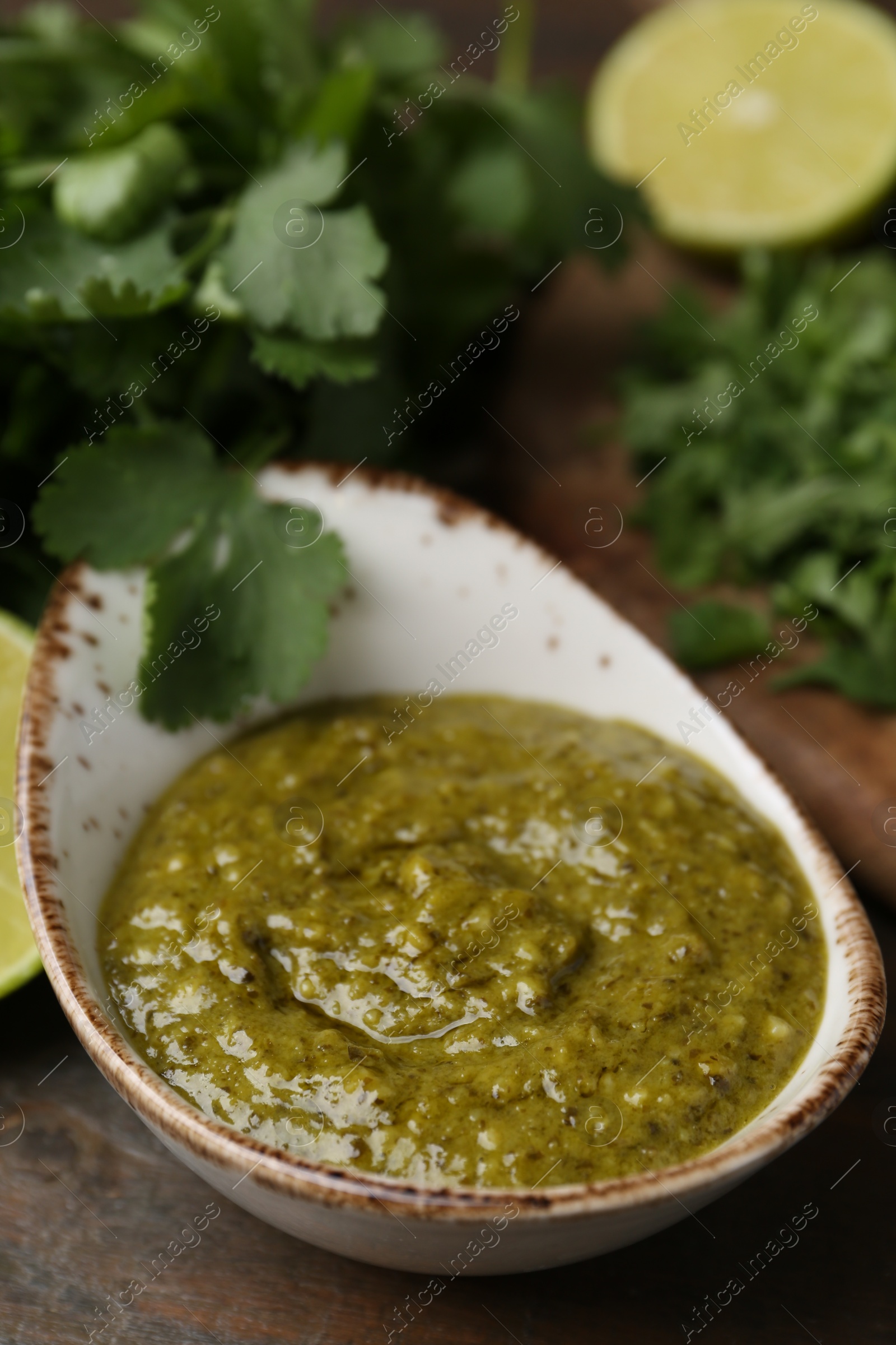 Tasty sauce with cilantro on table, closeup Photo of Tasty sauce with cilantro on table, closeup
