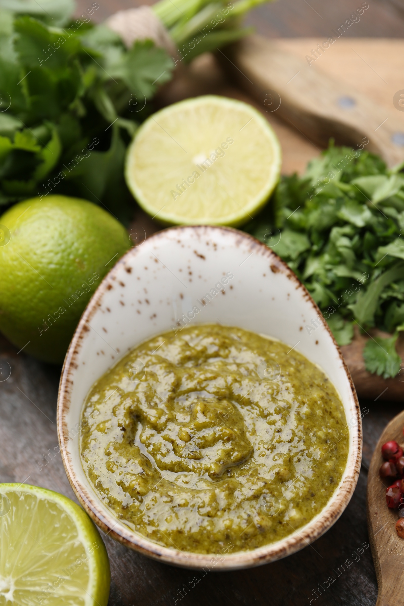 Tasty sauce with cilantro and other ingredients on table, closeup Photo of Tasty sauce with cilantro and other ingredients on table, closeup