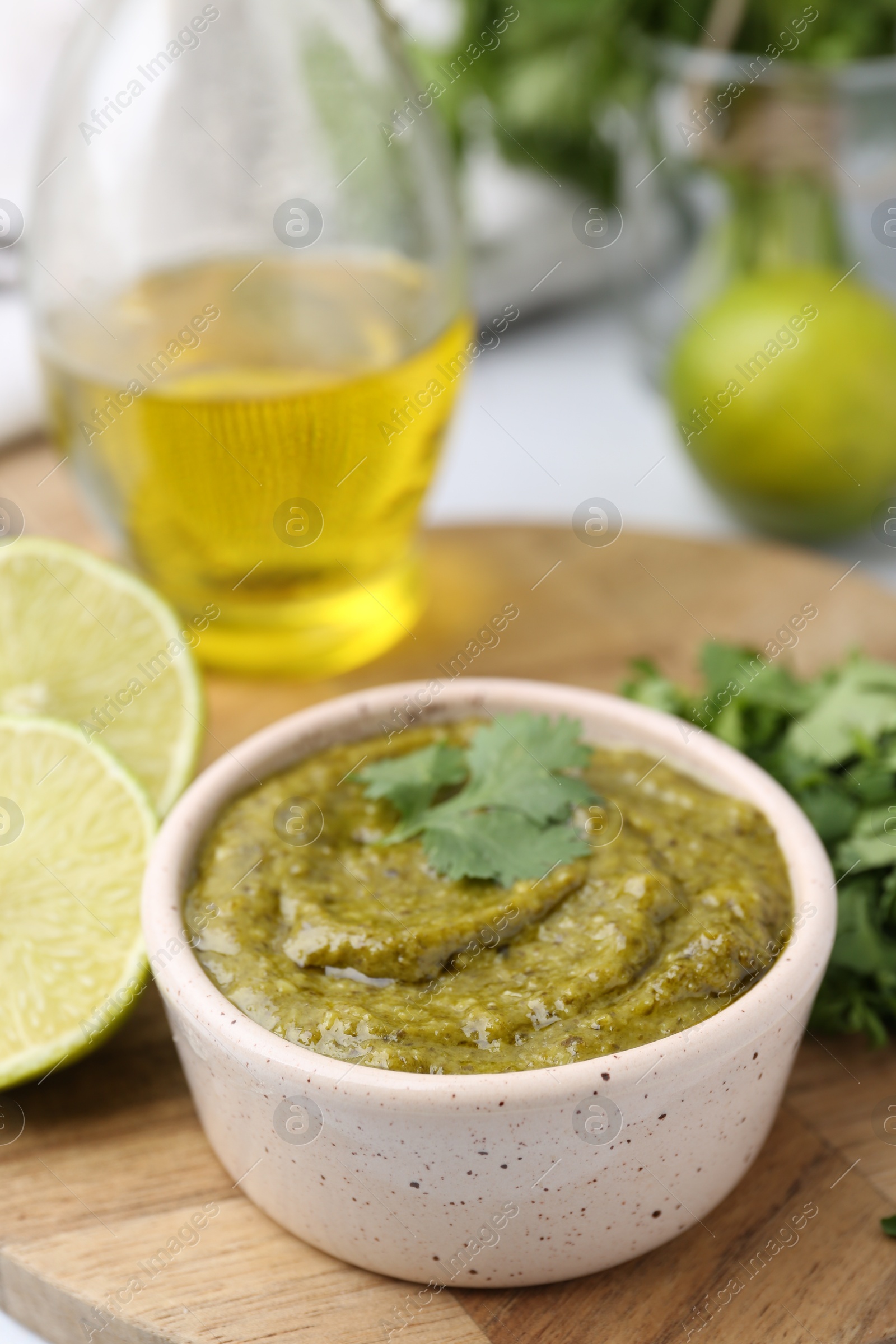 Tasty sauce with cilantro and other ingredients on table, closeup Photo of Tasty sauce with cilantro and other ingredients on table, closeup