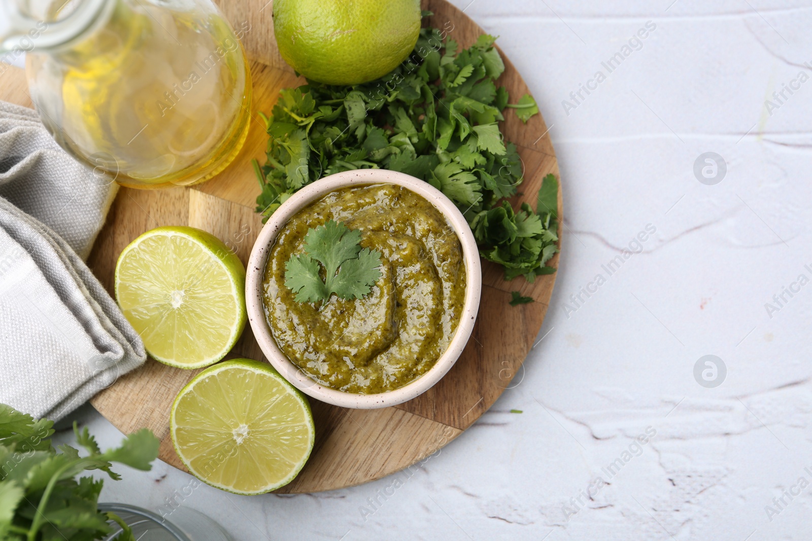 Tasty sauce with cilantro and other ingredients on white table, flat lay. Space for text Photo of Tasty sauce with cilantro and other ingredients on white table, flat lay. Space for text