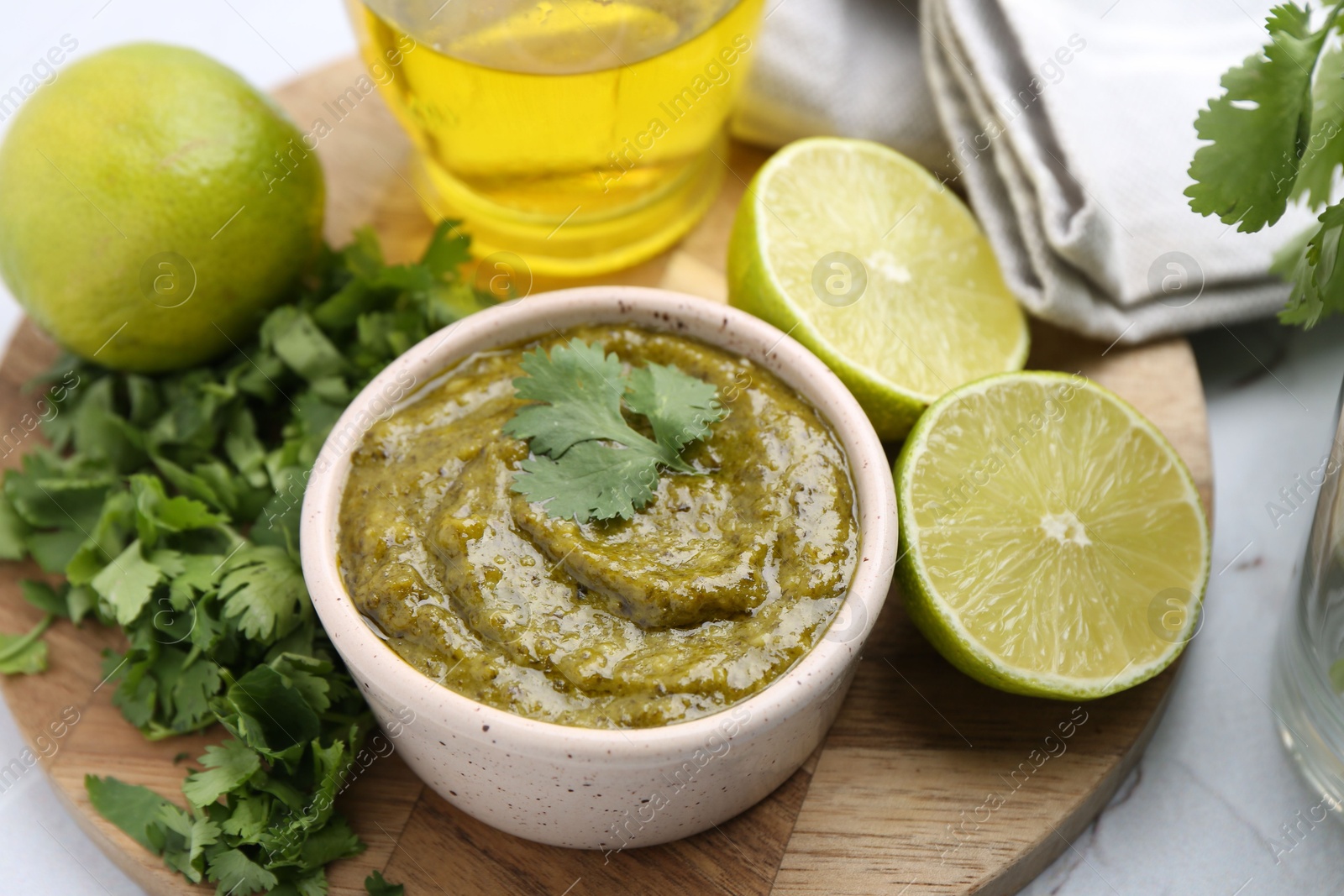 Tasty sauce with cilantro and other ingredients on white table, above view Photo of Tasty sauce with cilantro and other ingredients on white table, above view