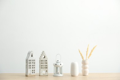 Photo of Different decor on wooden table near white wall indoors