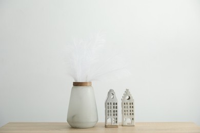 Photo of Different decor on wooden table near white wall indoors
