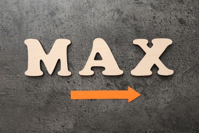 Photo of Word Max and arrow on grey table, flat lay