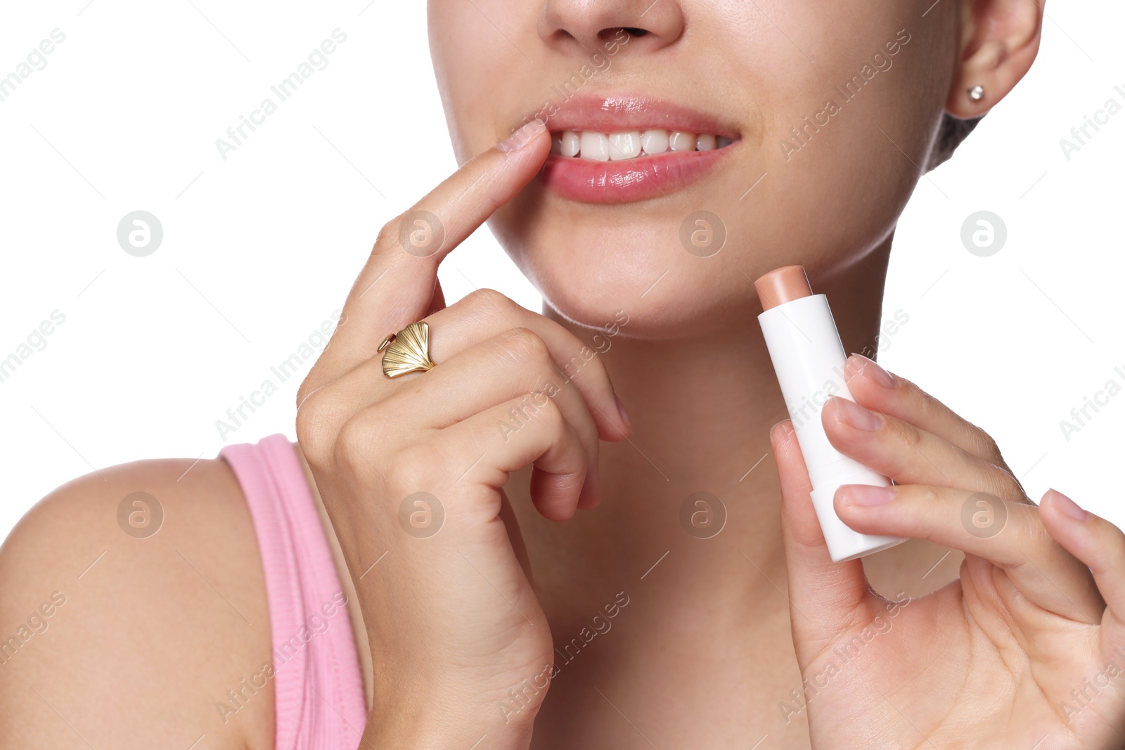 Young woman with lip balm on white background, closeup Photo of Young woman with lip balm on white background, closeup