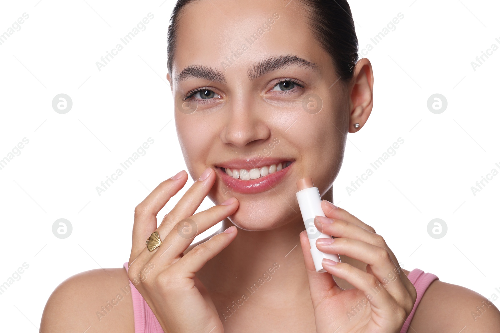 Young woman with lip balm on white background Photo of Young woman with lip balm on white background