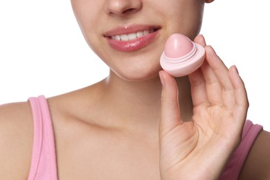 Photo of Young woman with lip balm on white background, closeup