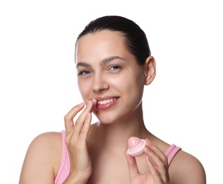 Photo of Young woman with lip balm on white background
