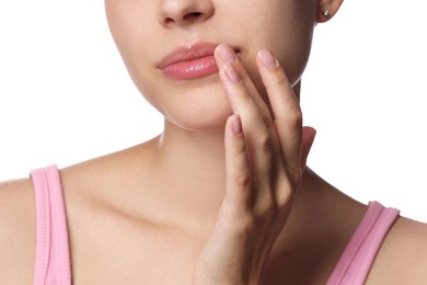 Photo of Young woman with lip balm on her lips against white background, closeup