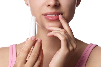 Photo of Young woman with lip balm on white background, closeup