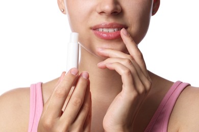 Photo of Young woman with lip balm on white background, closeup
