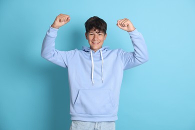 Photo of Portrait of teenage boy on light blue background
