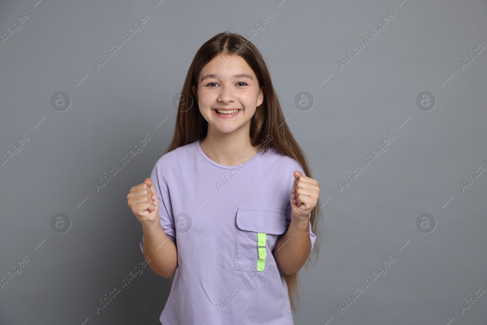 Portrait of teenage girl on grey background Photo of Portrait of teenage girl on grey background