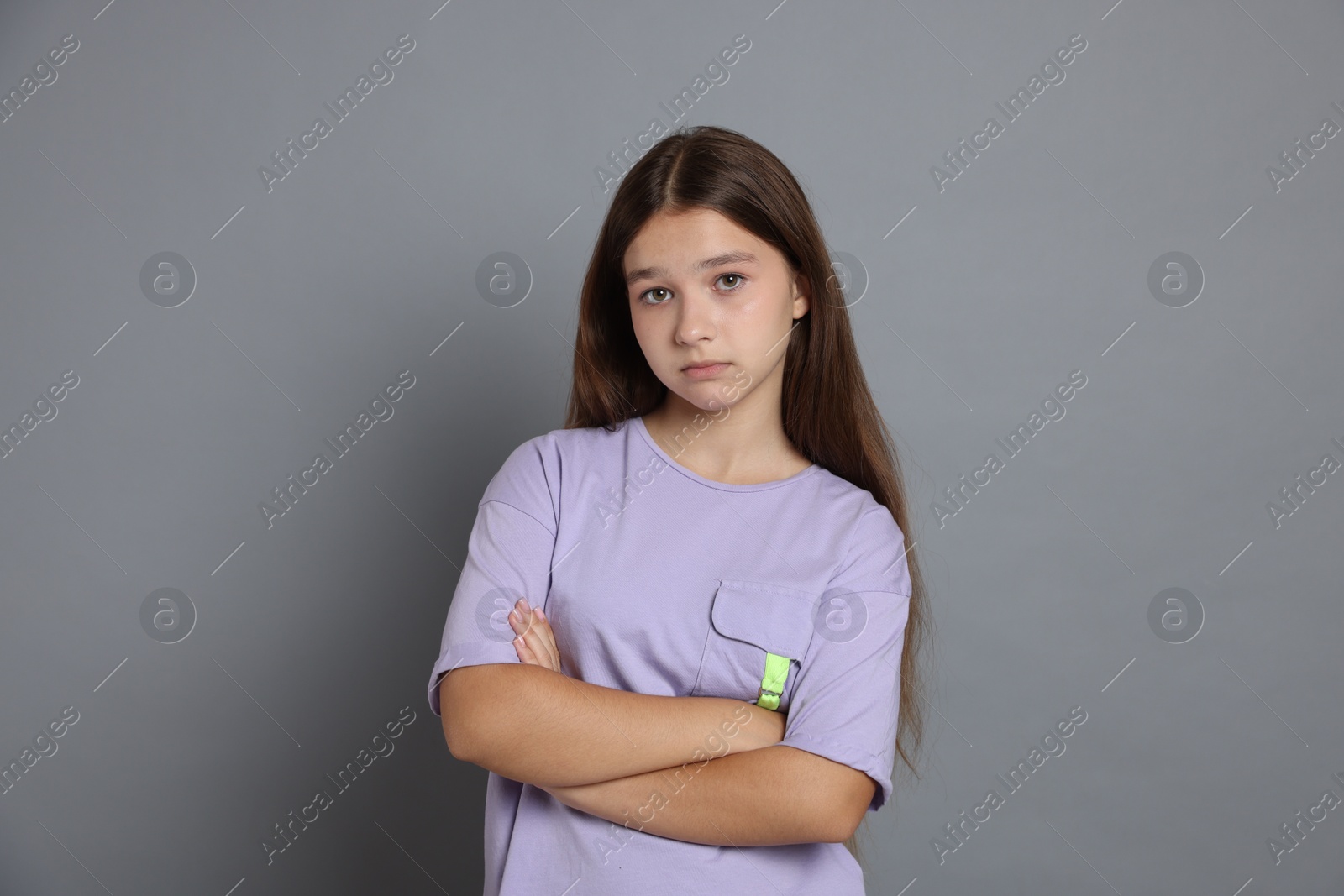 Portrait of teenage girl on grey background Photo of Portrait of teenage girl on grey background