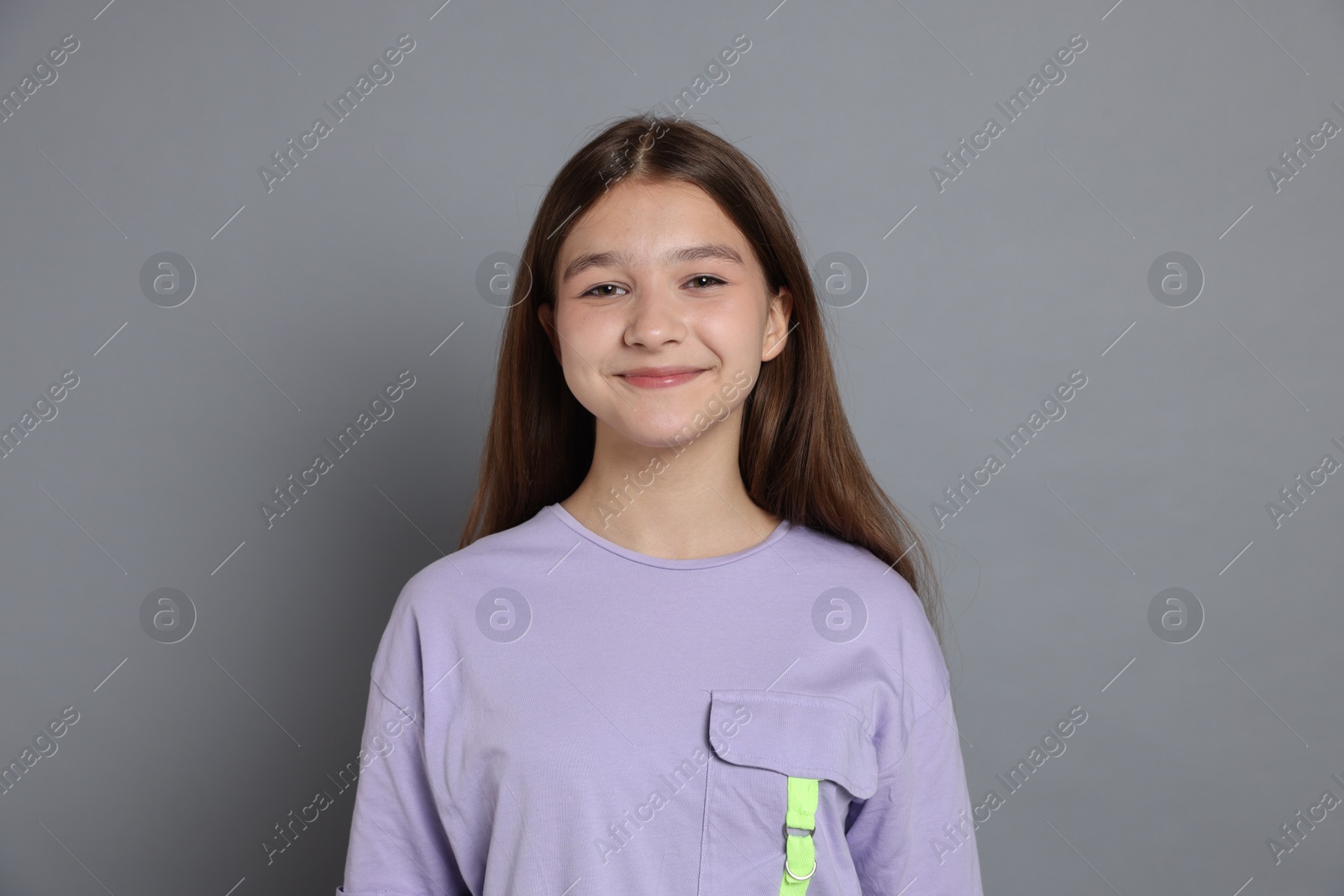 Portrait of teenage girl on grey background Photo of Portrait of teenage girl on grey background