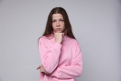 Photo of Portrait of teenage girl on light grey background