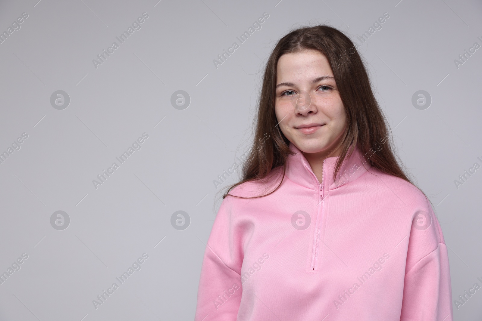 Photo of Portrait of teenage girl on light grey background, space for text