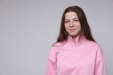 Photo of Portrait of teenage girl on light grey background, space for text