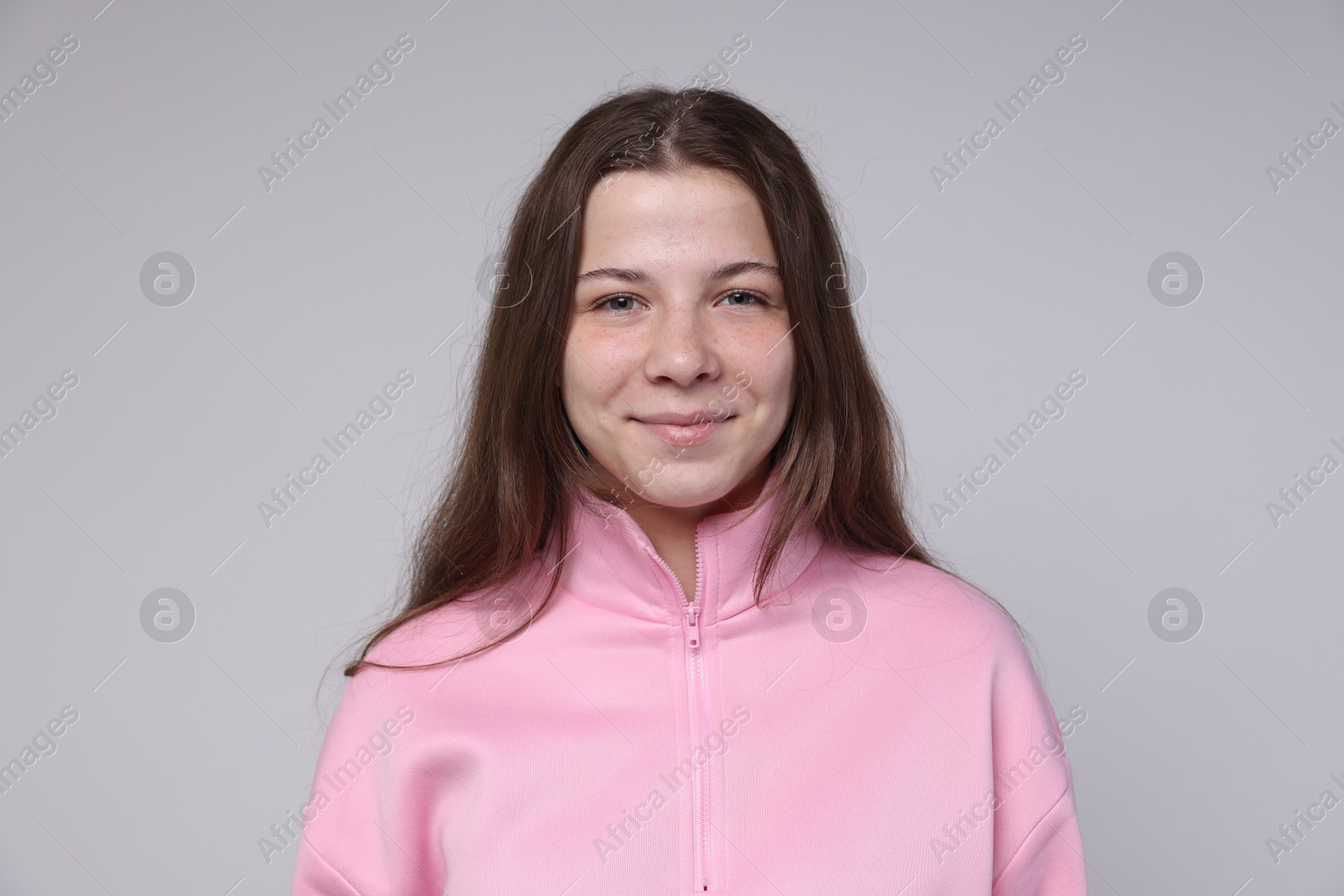Portrait of teenage girl on light grey background Photo of Portrait of teenage girl on light grey background
