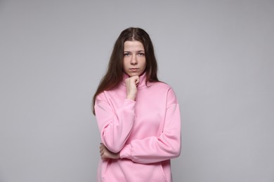 Photo of Portrait of teenage girl on light grey background