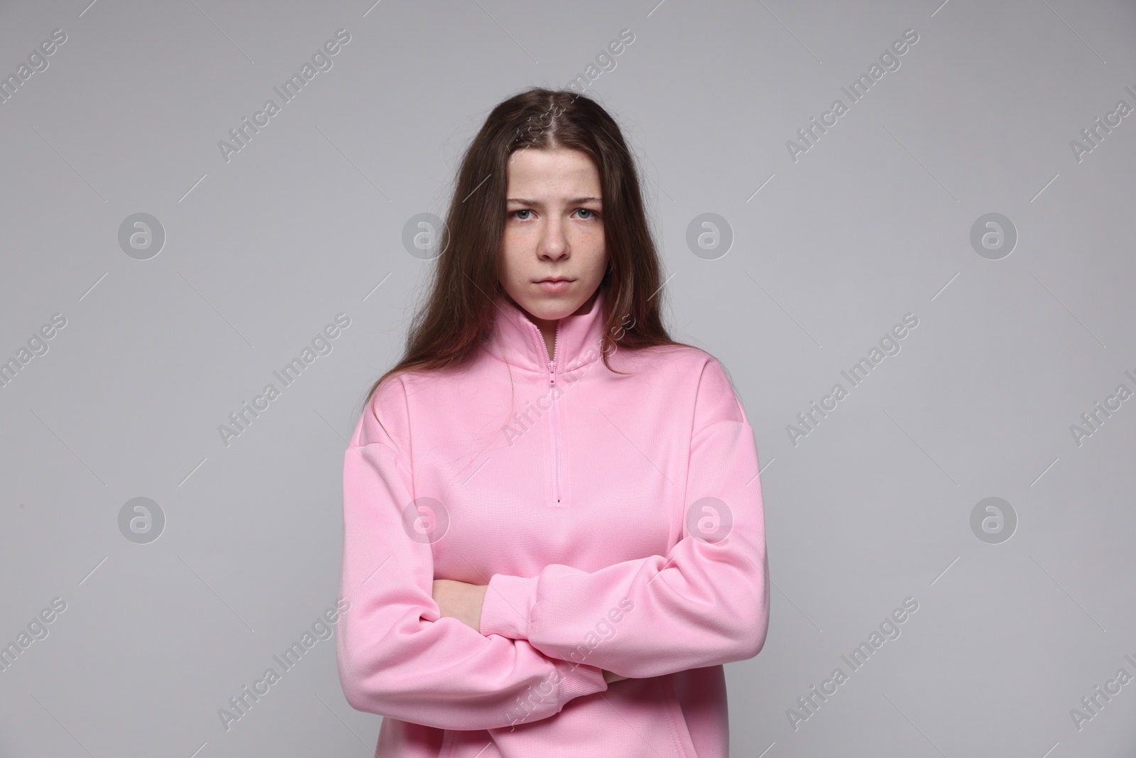 Portrait of teenage girl on light grey background Photo of Portrait of teenage girl on light grey background