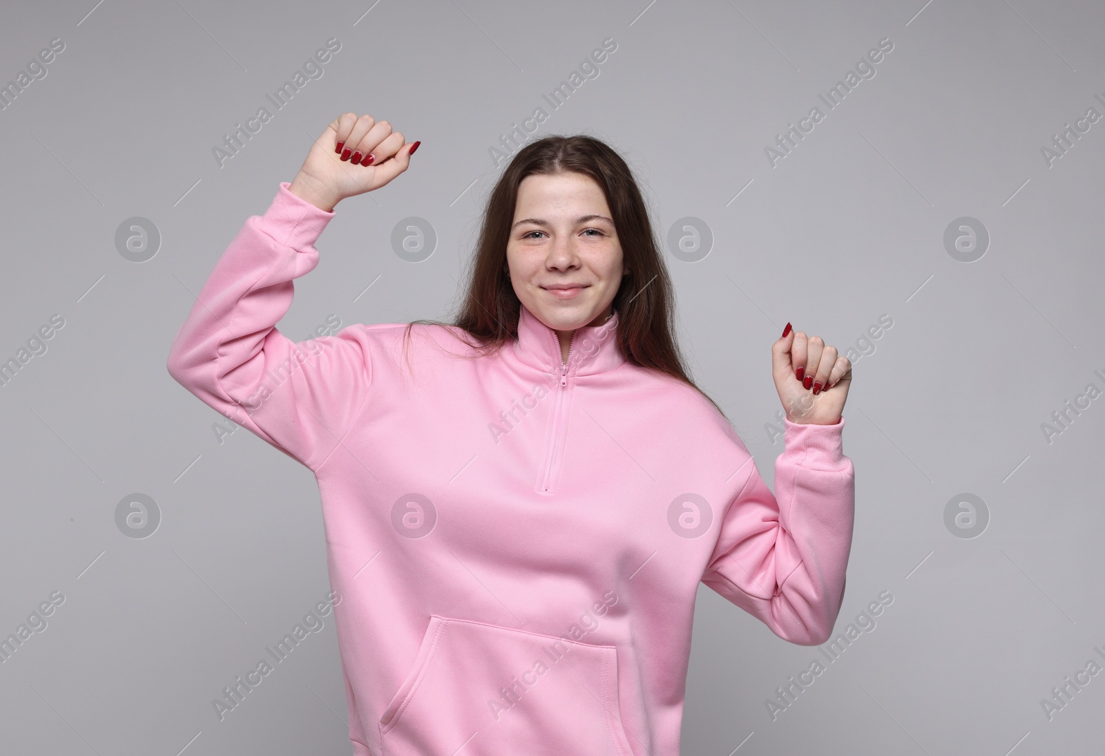 Portrait of teenage girl on light grey background Photo of Portrait of teenage girl on light grey background