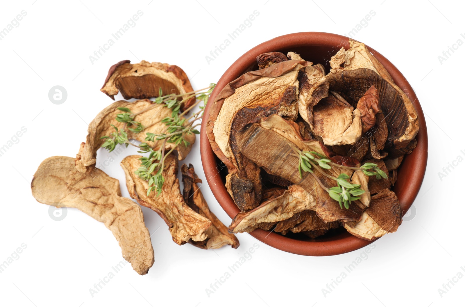 Photo of Pieces of dried mushrooms and rosemary in bowl isolated on white, top view