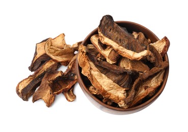 Photo of Pieces of dried mushrooms in bowl isolated on white, top view