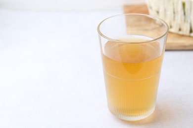 Photo of Glass with dirty water on light table, closeup. Space for text