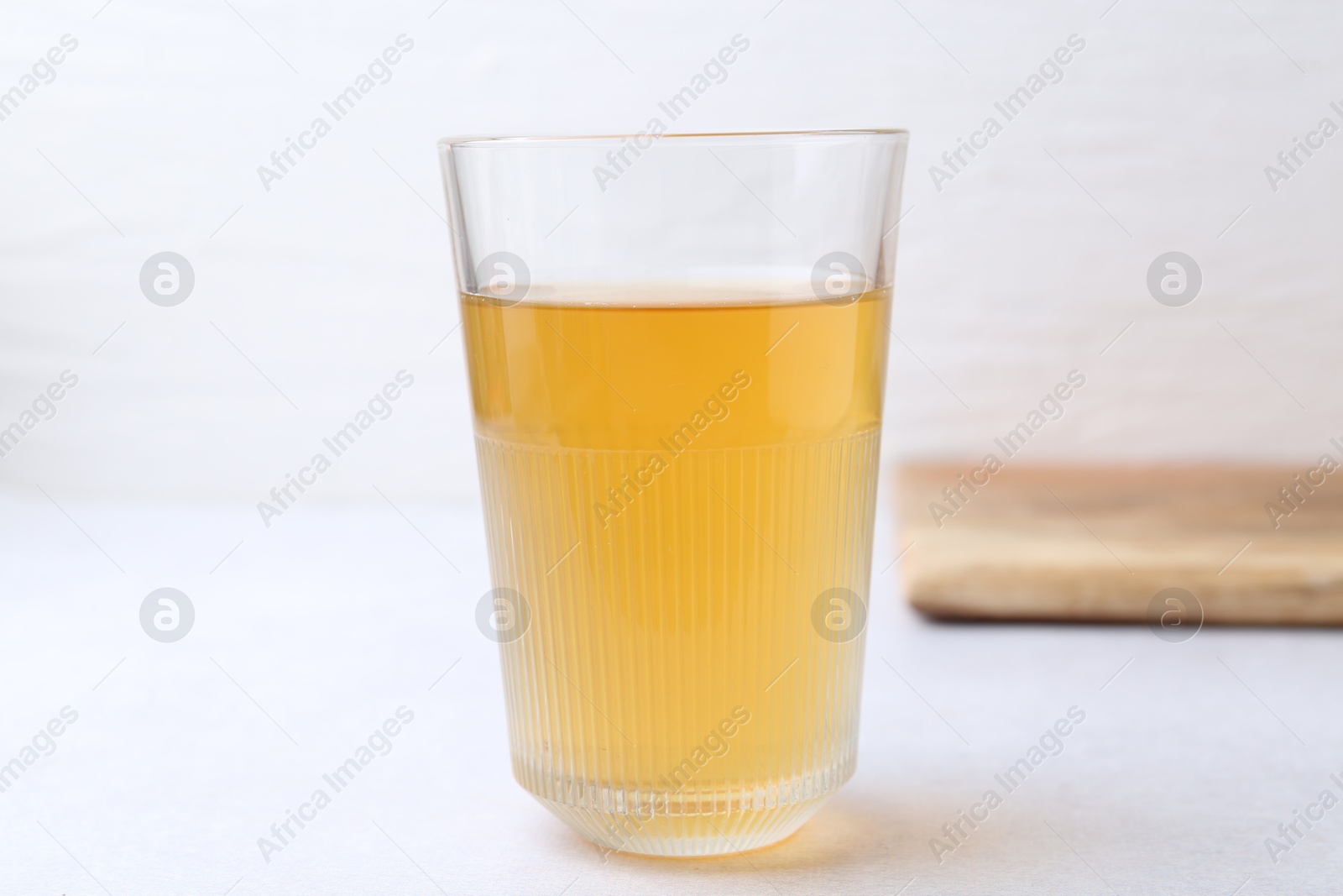 Photo of Glass with dirty water on light table, closeup
