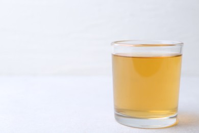 Photo of Glass with dirty water on light table, closeup. Space for text