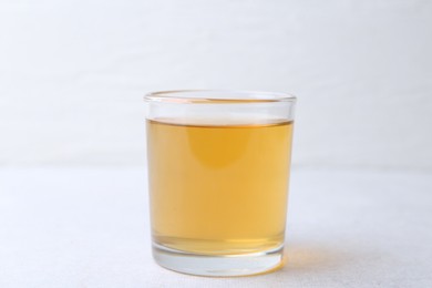 Photo of Glass with dirty water on light table, closeup