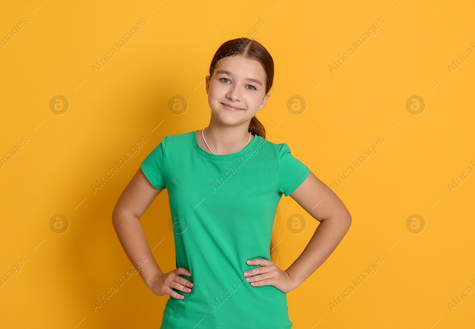 Portrait of teenage girl on orange background Photo of Portrait of teenage girl on orange background