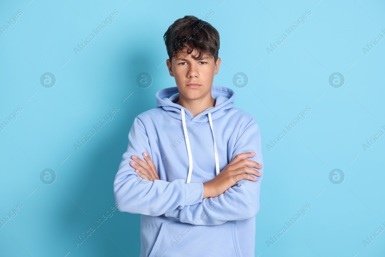 Portrait of teenage boy on light blue background Photo of Portrait of teenage boy on light blue background