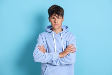 Photo of Portrait of teenage boy on light blue background