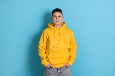 Photo of Portrait of teenage boy on light blue background