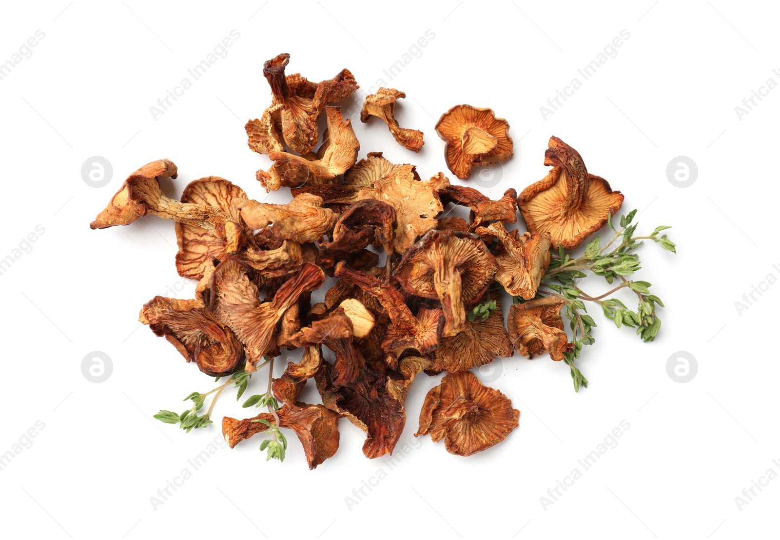 Photo of Dried chanterelle mushrooms and thyme isolated on white, top view