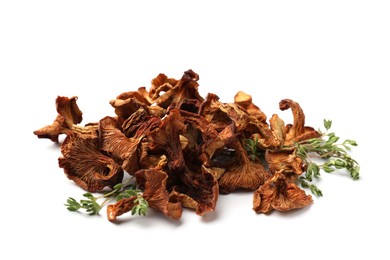 Photo of Dried chanterelle mushrooms and thyme isolated on white