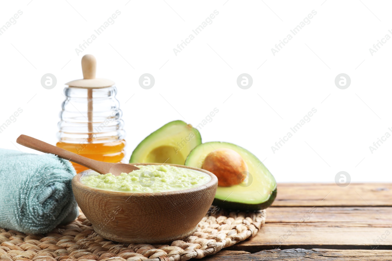 Homemade hair mask in bowl, fresh ingredients and towel on wooden table against white background. Space for text Photo of Homemade hair mask in bowl, fresh ingredients and towel on wooden table against white background. Space for text