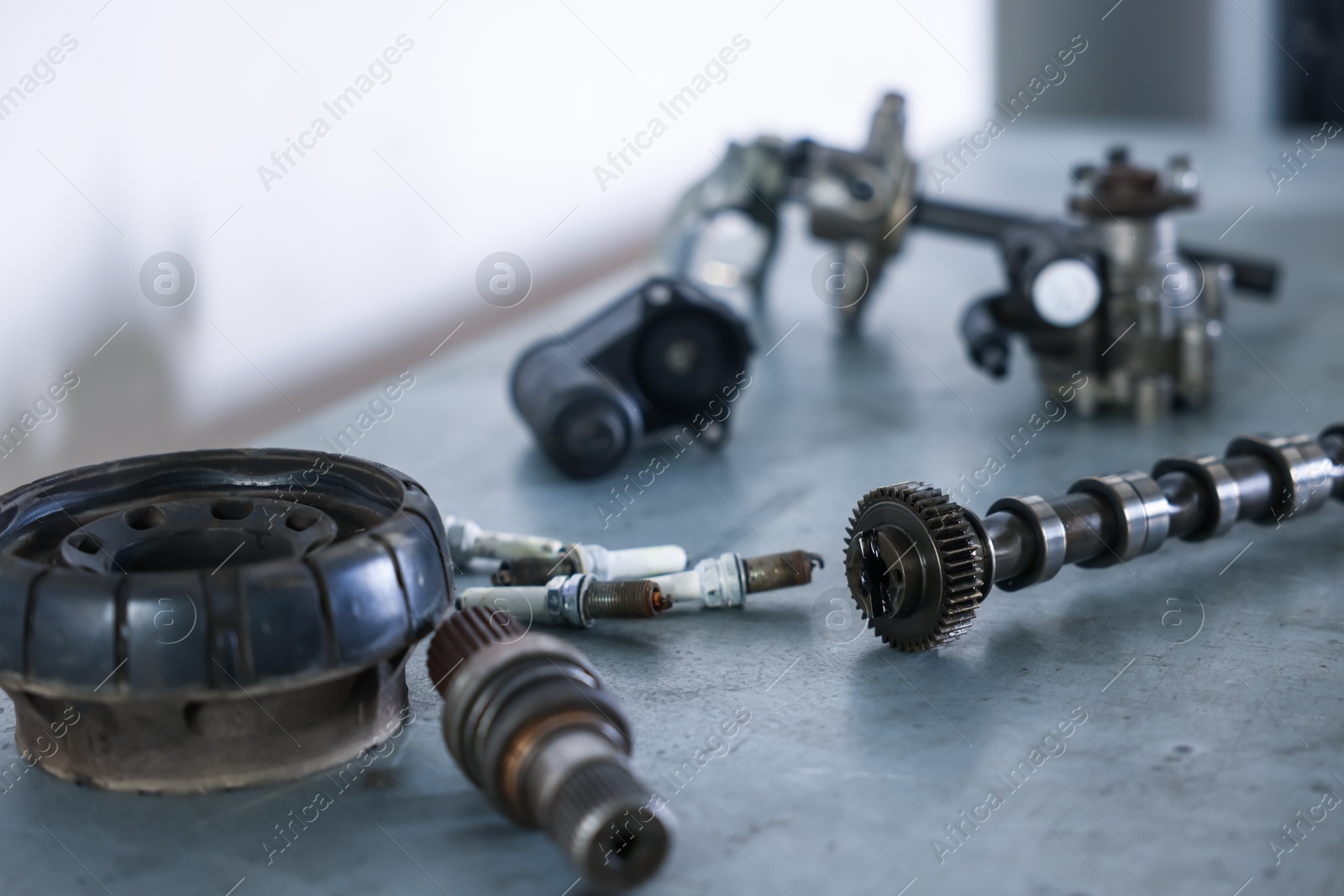 Different auto parts on grey table indoors, closeup Photo of Different auto parts on grey table indoors, closeup