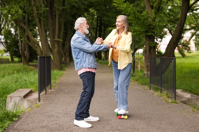 Photo of Lovely senior couple having fun together in park