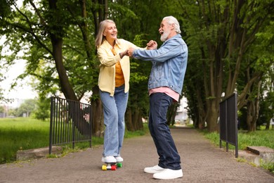 Photo of Lovely senior couple having fun together in park