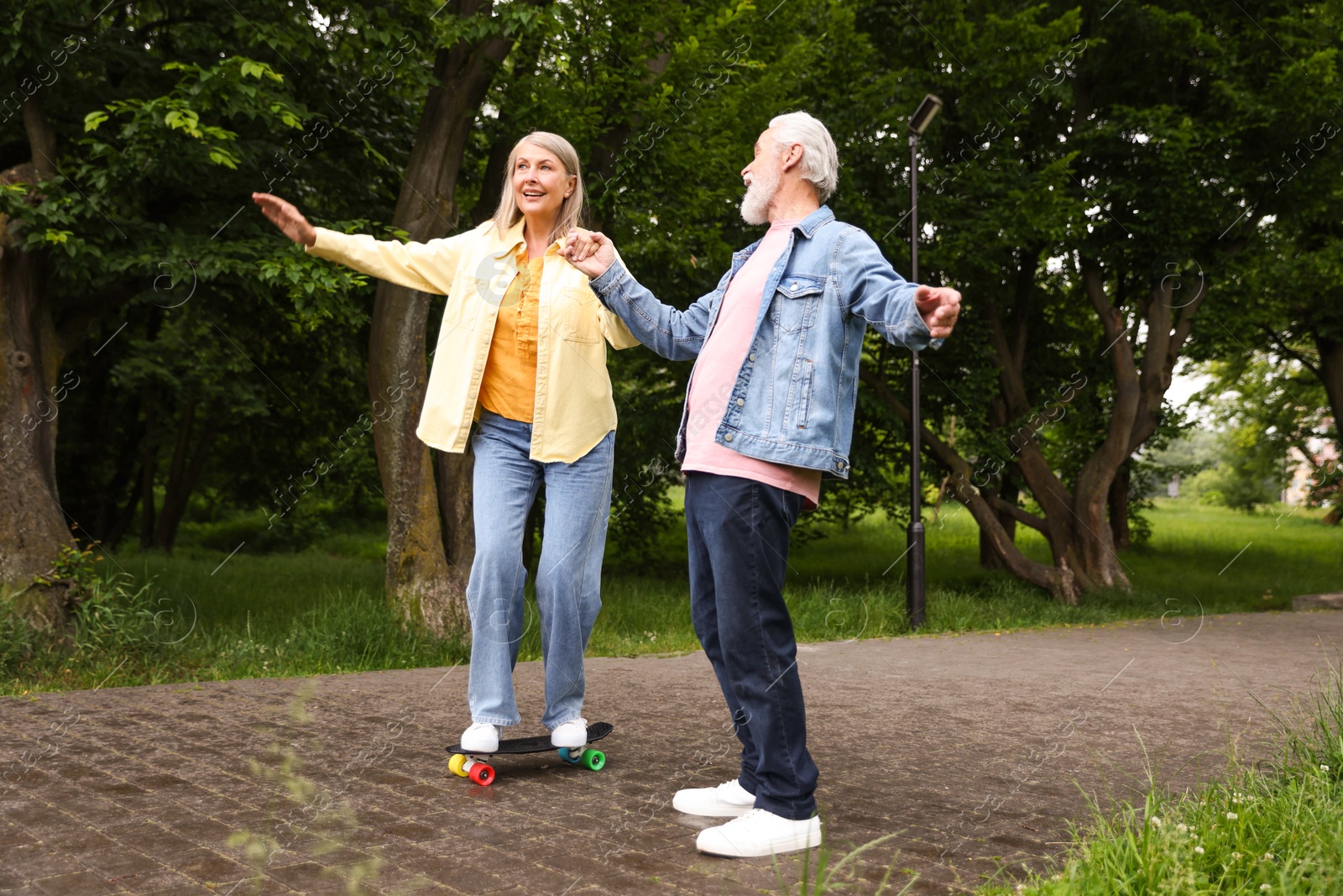 Lovely senior couple having fun together in park Photo of Lovely senior couple having fun together in park