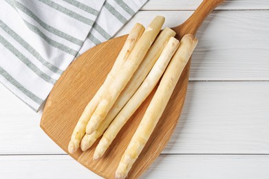 Photo of Raw asparagus spears on white wooden table, top view