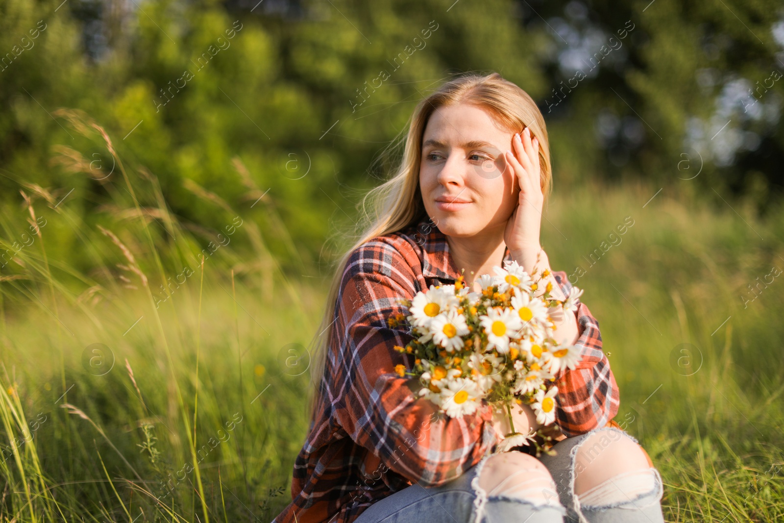 Beautiful woman with wildflowers enjoying summer day in meadow. Space for text Photo of Beautiful woman with wildflowers enjoying summer day in meadow. Space for text